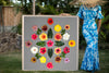Woman in a Hawaiian mumu holding a large 4ftx4ft print called Rainbow Kiss, inspired by the Hawaiian quilt