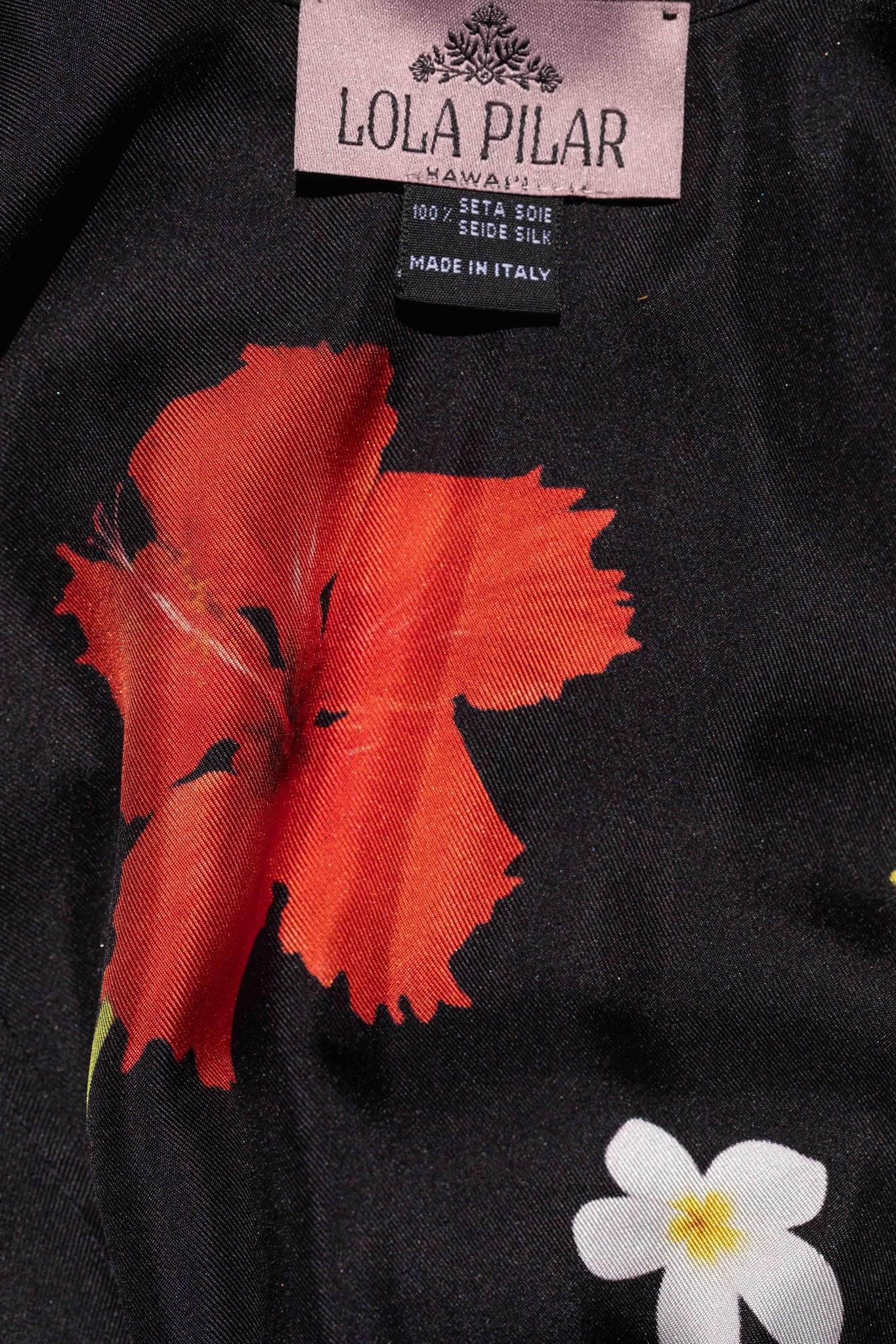 Black silk robe featuring hanging heliconia, hibiscus, banana flowers, and plumeria in a vibrant tropical print designed in Hawaii.
