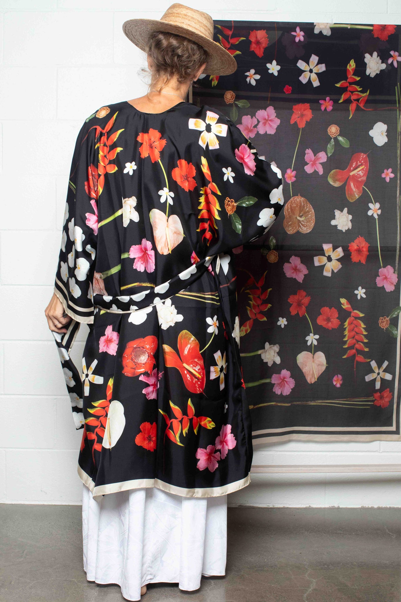 Lola Pilar black silk kimono robe with vibrant Hawaiian floral print featuring hibiscus, torch ginger, hanging heliconia, plumeria, and banana flowers, made in Italy and designed in Hawaii.