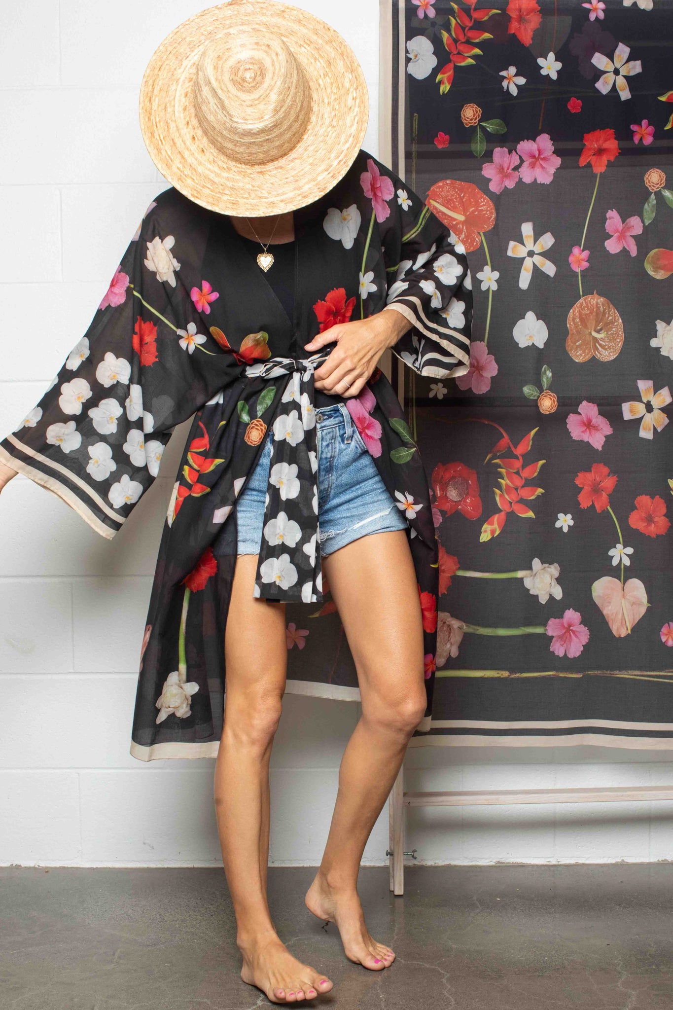 Chic Hawaiian floral kimono robe featuring a dramatic black backdrop with hibiscus, hanging heliconia, torch ginger, and plumeria for timeless tropical elegance.