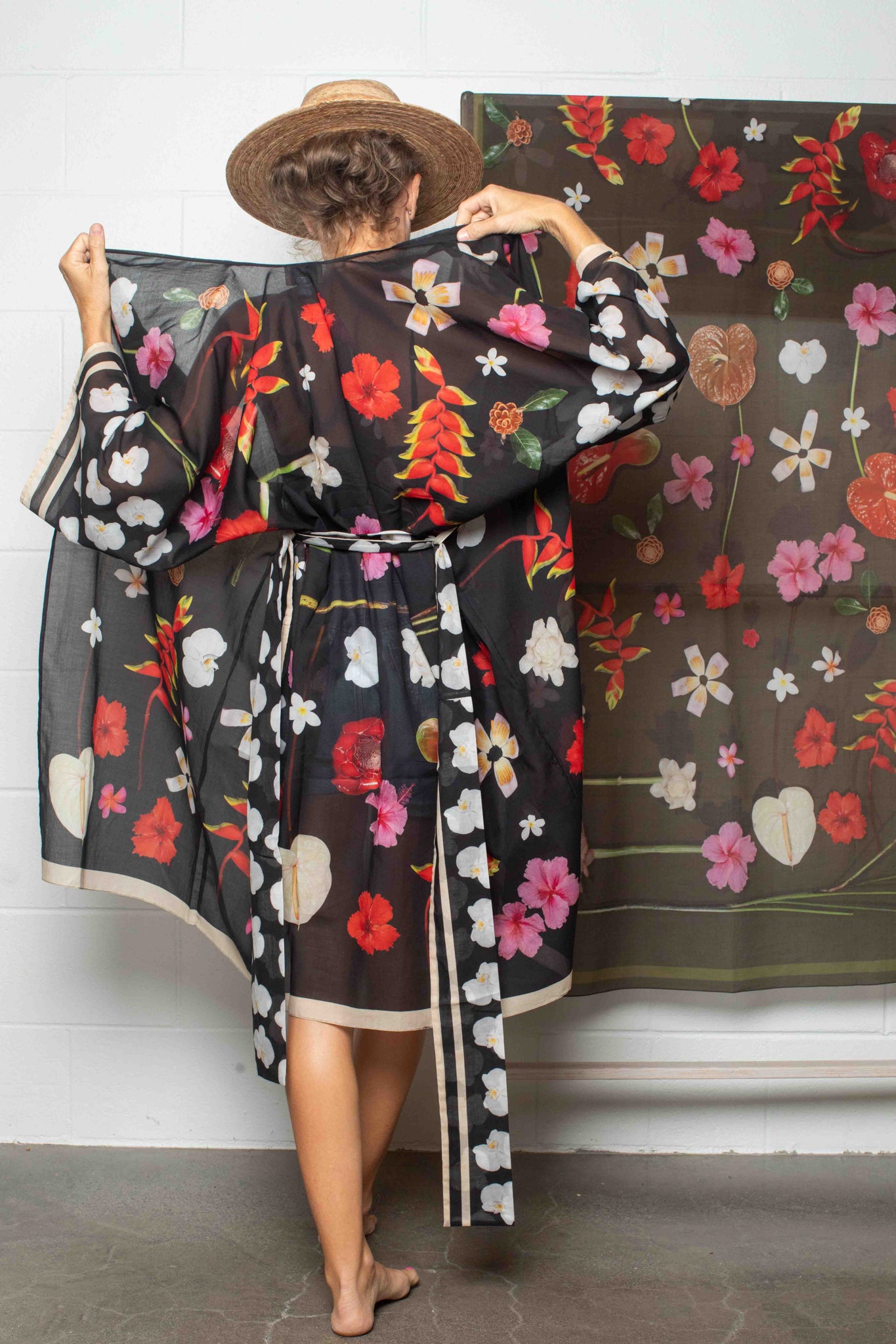 Designer cotton kimono robe with black background and vivid Hawaiian floral pattern, made in Italy and designed in Hawaii for modern island-inspired fashion.

