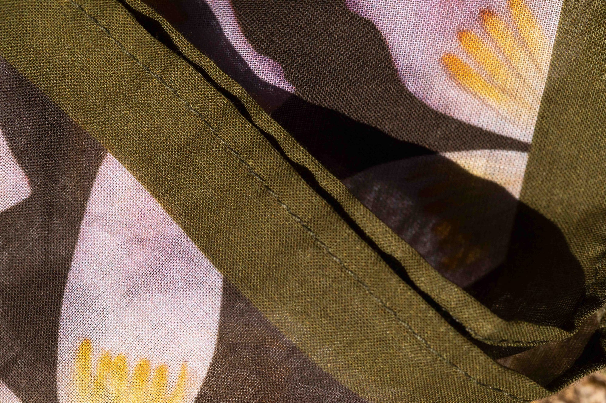 Luxury-inspired tropical cotton kimono top with colorful floral print on moss green fabric designed for stylish travel and island living.