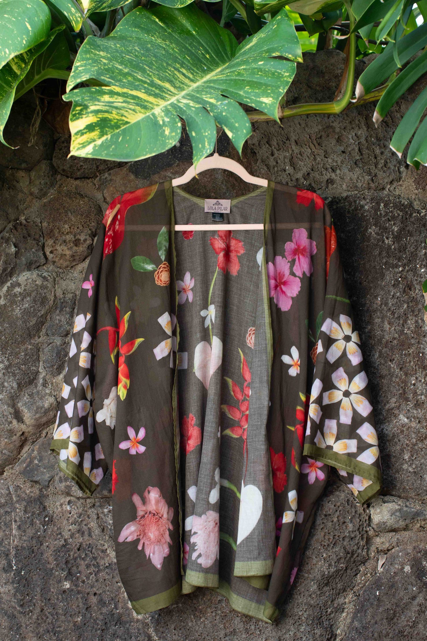 Elevated island kimono top with moss green background and sophisticated Hawaiian floral pattern in rich tropical tones.