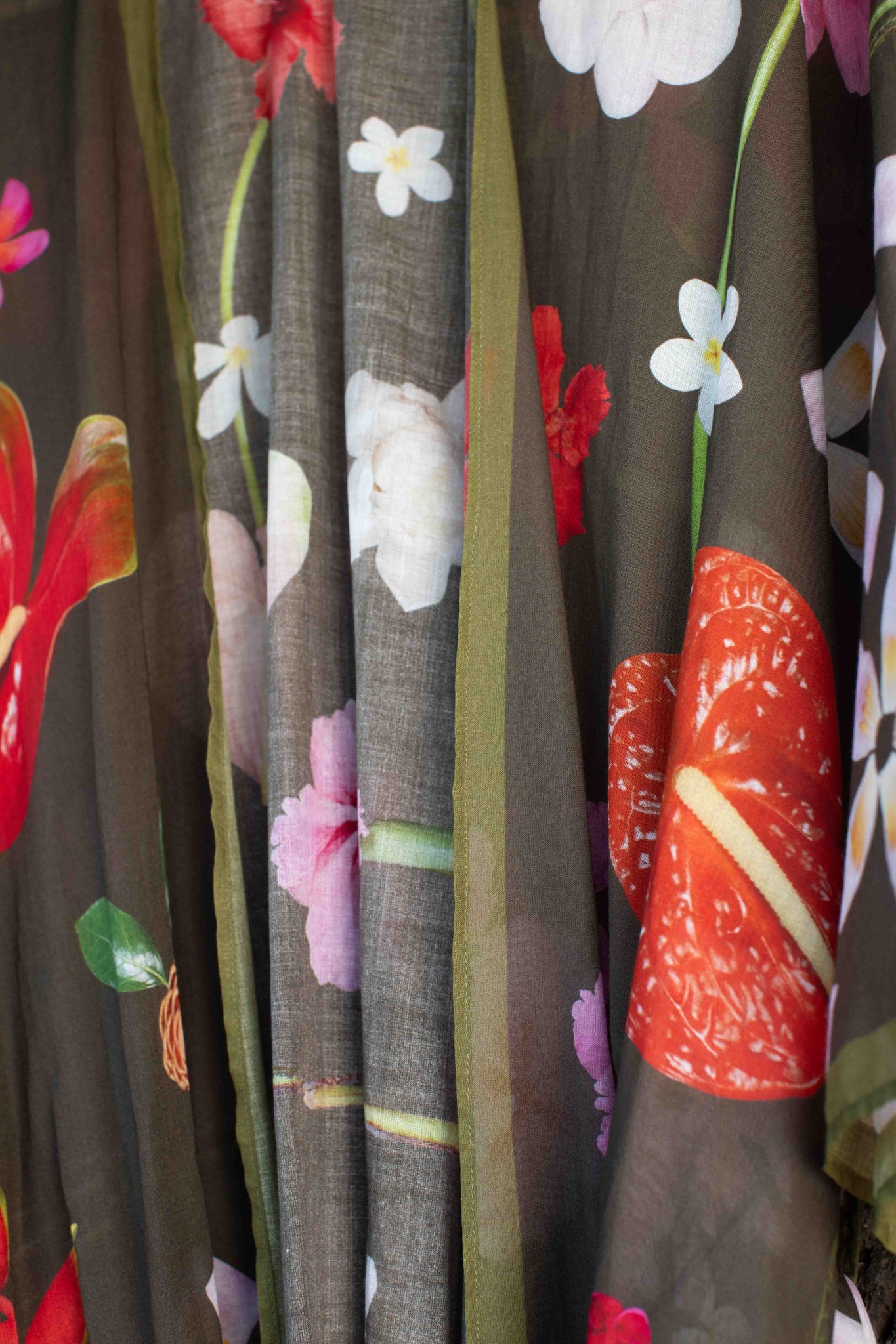 Exotic floral resort kimono robe with moss green background and bold Hawaiian-inspired flowers in pink, yellow, red, and white tones.