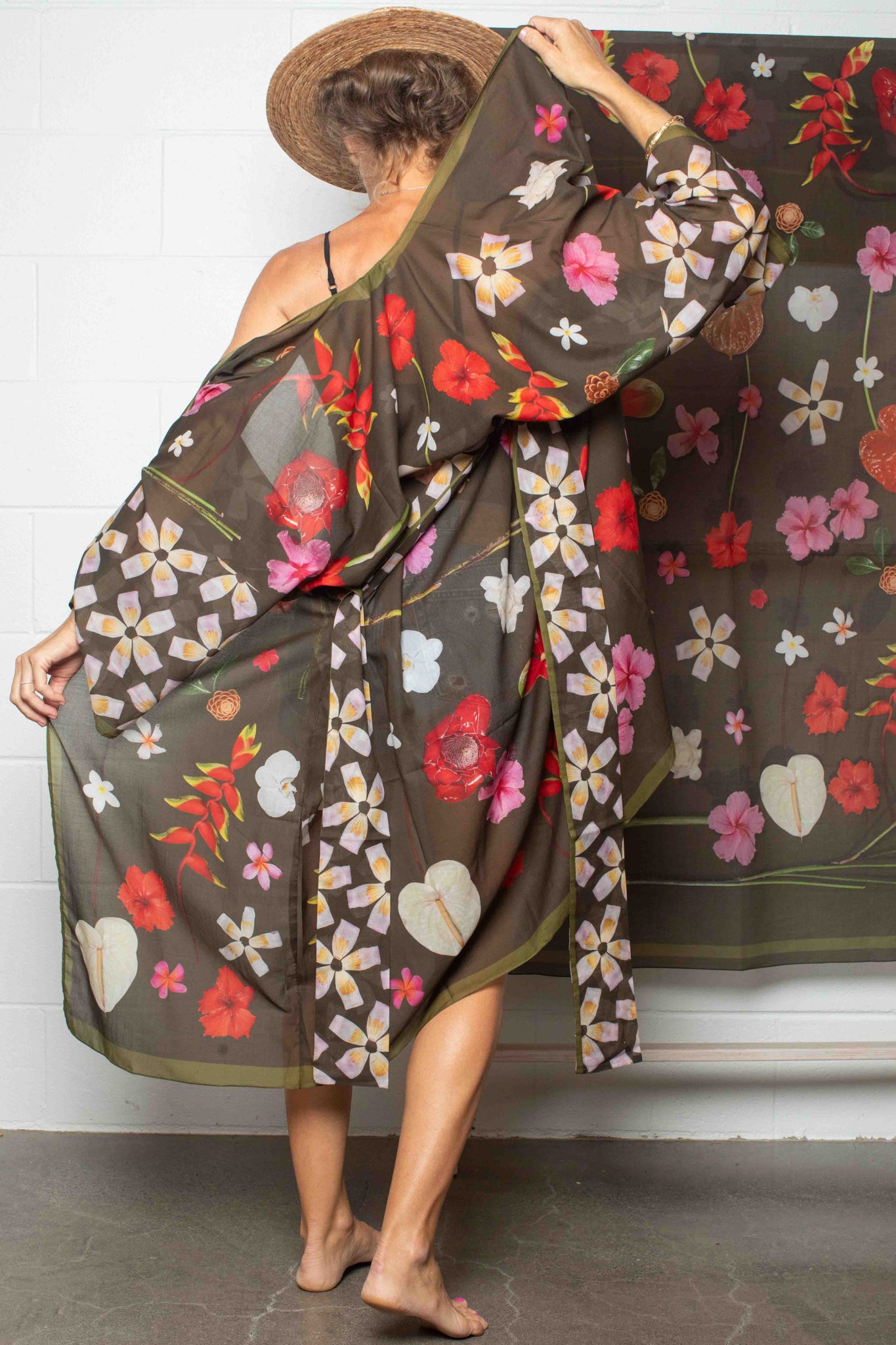 Hawaiian floral kimono robe by Lola Pilar with moss green backdrop and colorful hibiscus, heliconia, torch ginger, and plumeria print, made in Italy and designed in Hawaii.