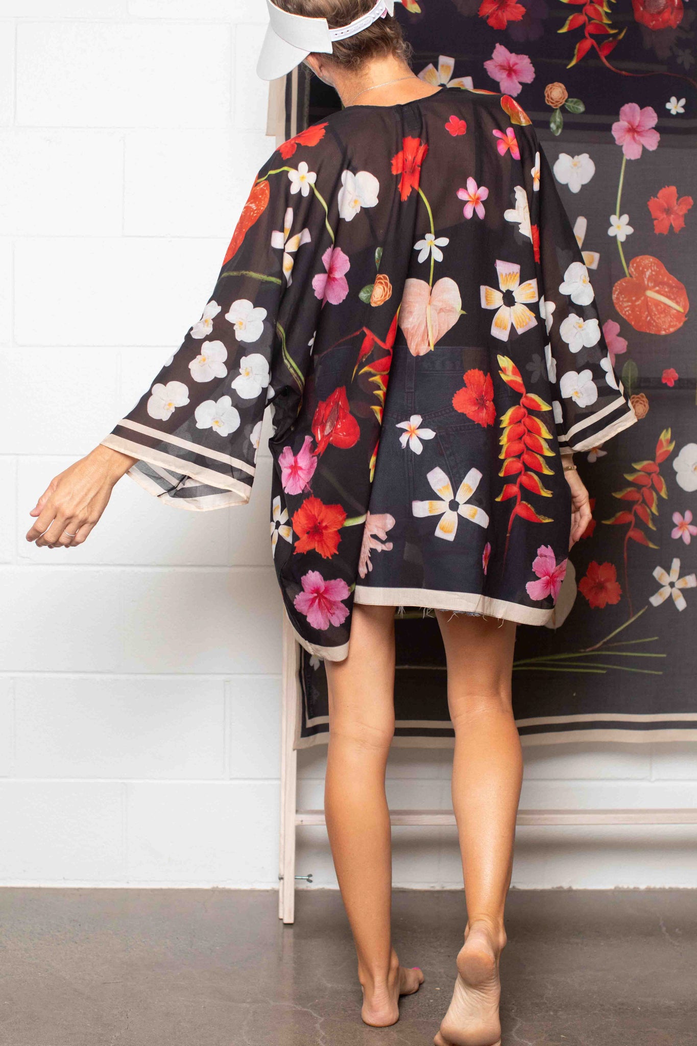 Lightweight black cotton kimono cover-up with vibrant tropical Hawaiian blooms in pink, yellow, red, and white for chic resort dressing.