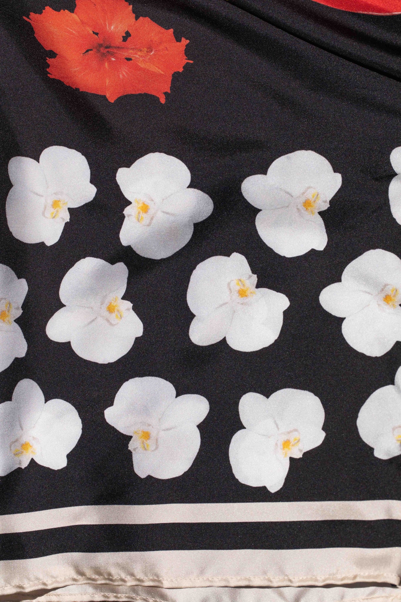 Italian-made silk kimono robe with dramatic black background and lush Hawaiian botanical print by Lola Pilar, designed for sophisticated vacation wear.