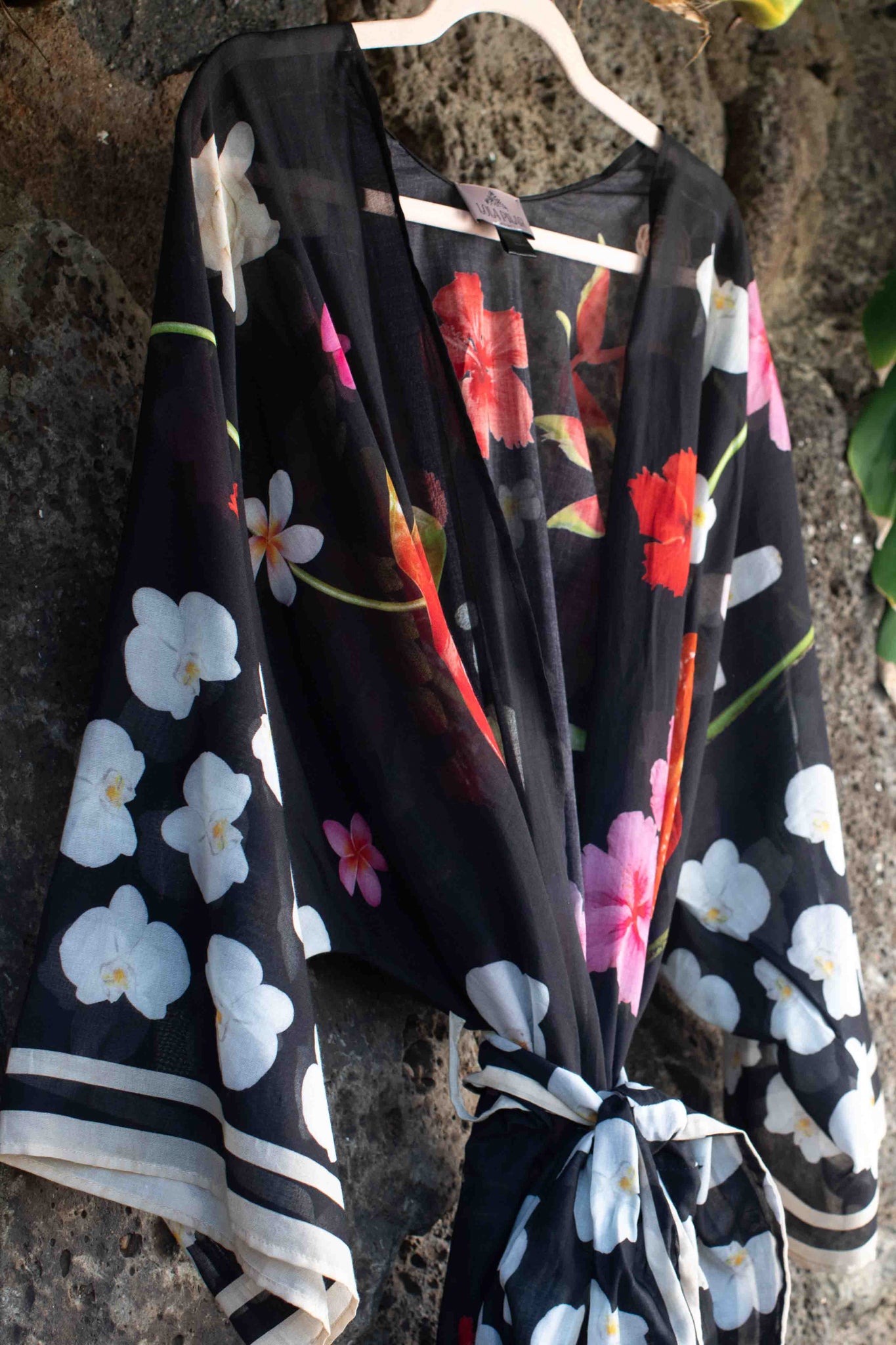 Lola Pilar black floral robe crafted in cotton with luxurious tropical flower print inspired by Hawaii and tailored for chic travel and resort wear.