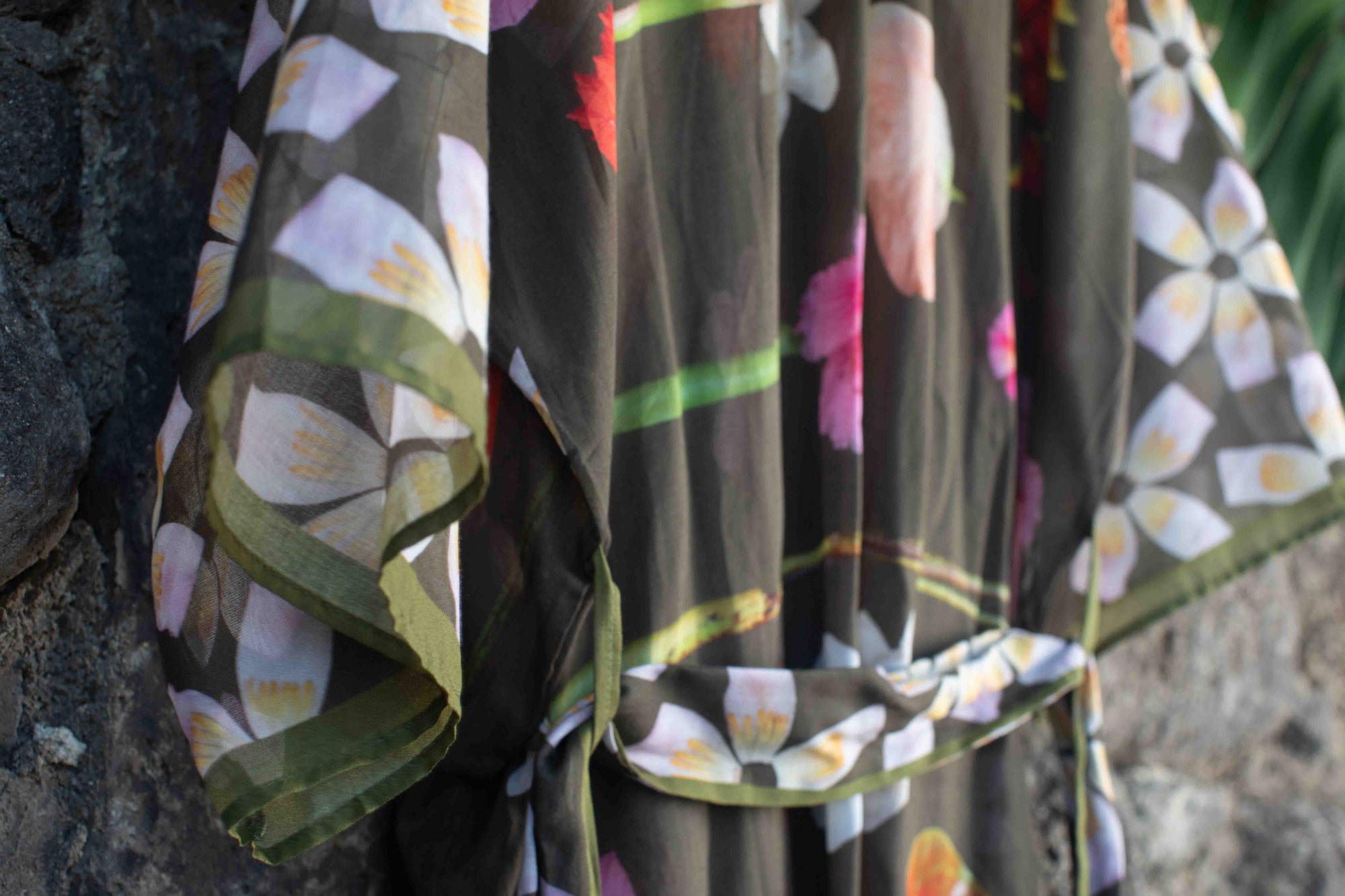 Lola Pilar moss green robe showcasing tropical hibiscus, torch ginger, banana flowers, and hanging heliconia in a vibrant island floral print.