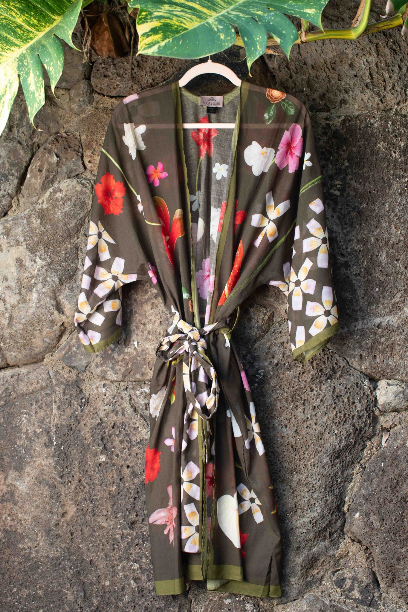 Luxury island kimono robe featuring tropical Hawaiian flowers on a moss green background with pink, yellow, red, and white botanical accents.