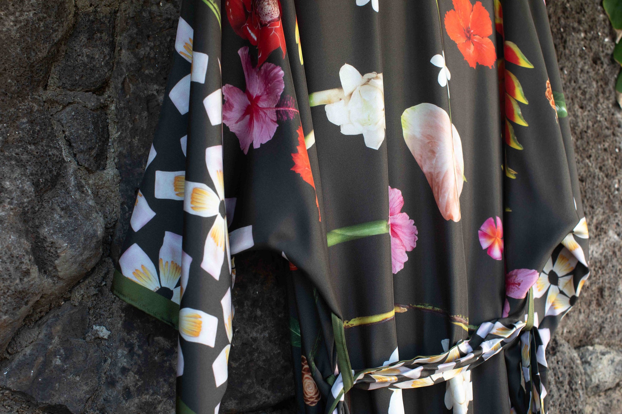 Lola Pilar moss green silk kimono robe with vibrant Hawaiian floral print featuring hibiscus, heliconia, torch ginger, plumeria, and banana flowers.