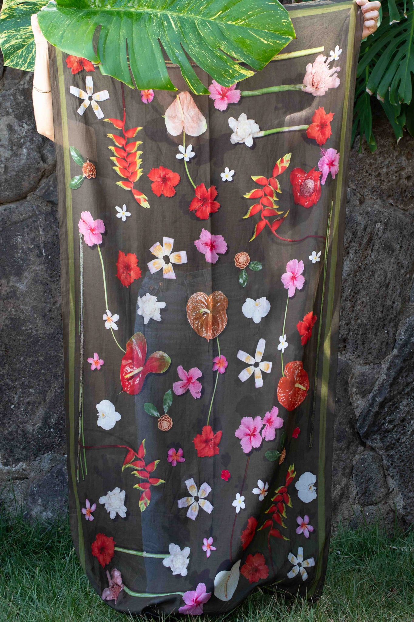Lola Pilar tropical sarong with moss green background featuring hibiscus, torch ginger, hanging heliconia, plumeria, and banana flowers in pink, yellow, red, and white, made in Italy and designed in Hawaii.