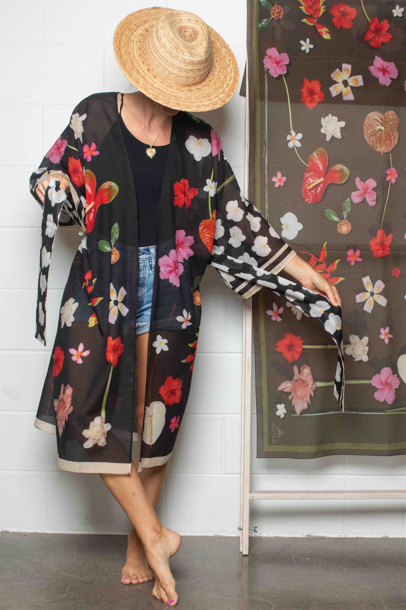 Premium cotton travel kimono by Lola Pilar with refined black tropical floral print, crafted in Italy and designed in Hawaii for sophisticated island-inspired fashion.

