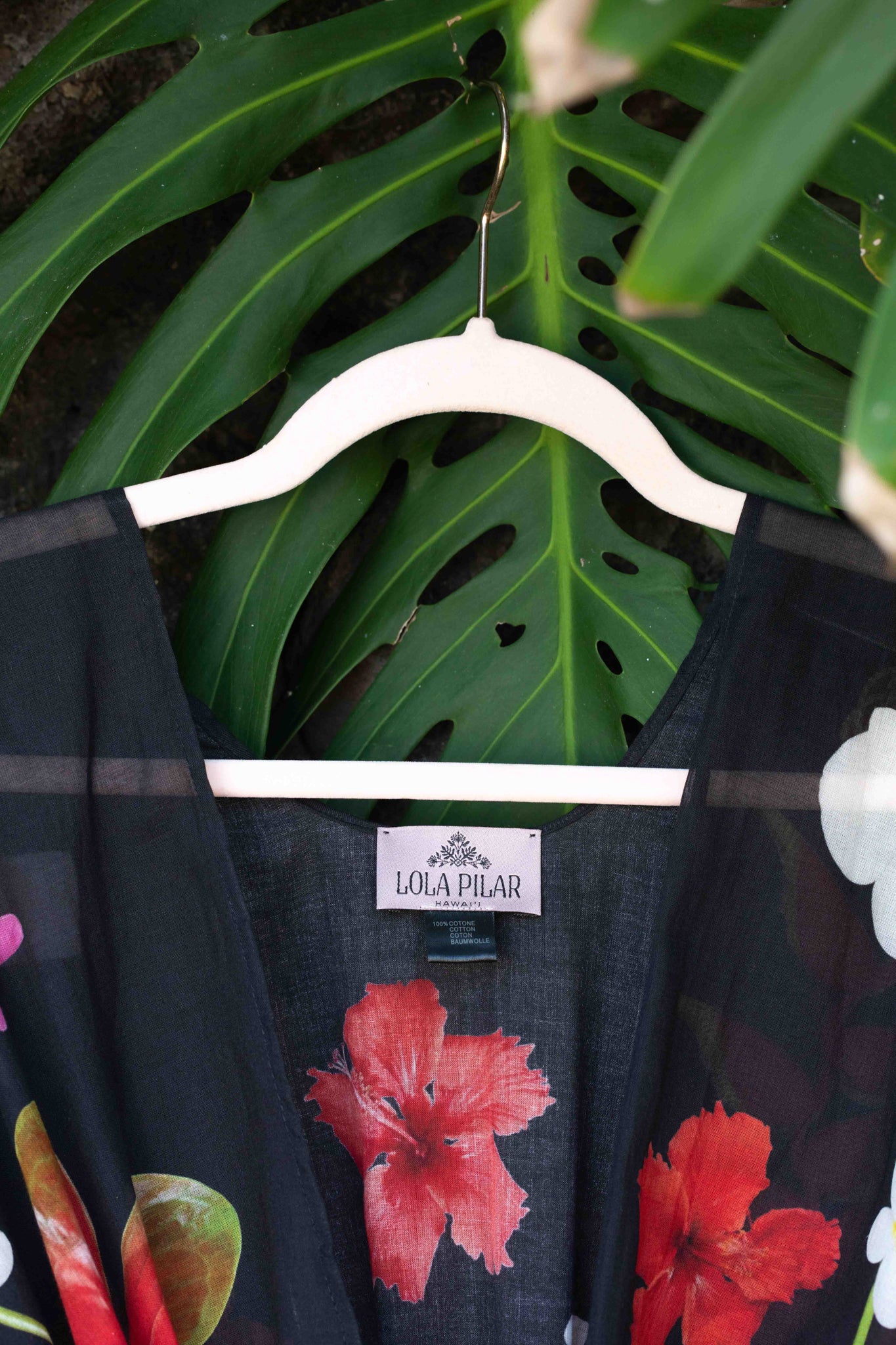 Resort-ready black cotton kimono top with vivid island floral design showcasing torch ginger, banana flowers, and hibiscus blooms.