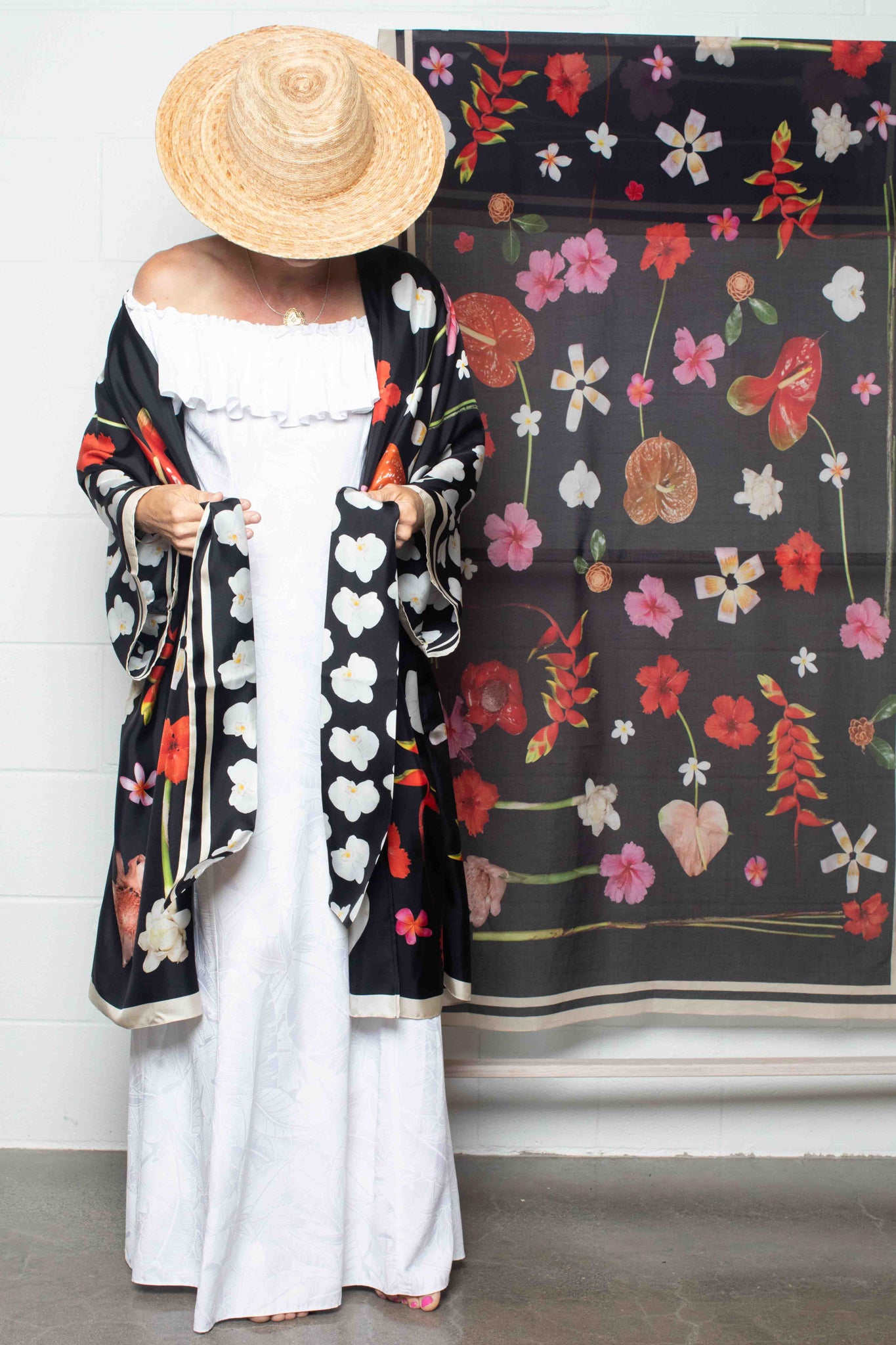 Tropical black silk travel robe with lush island botanical design in vibrant pink, red, yellow, and white tones, made in Italy and designed in Hawaii.
