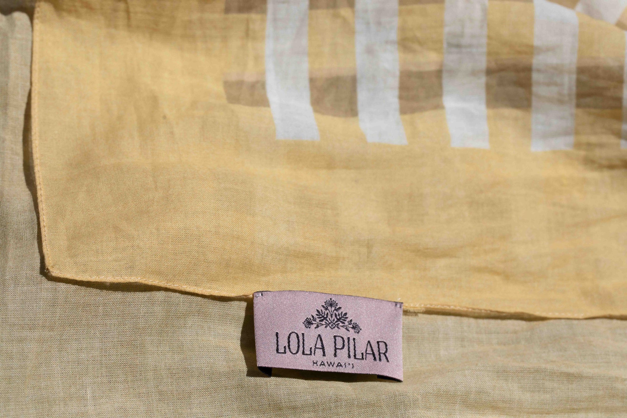 Tropical travel scarf with yellow and white check palaka styling and “I Love Hawaii” print paired with a red anthurium flower Lola Pilar