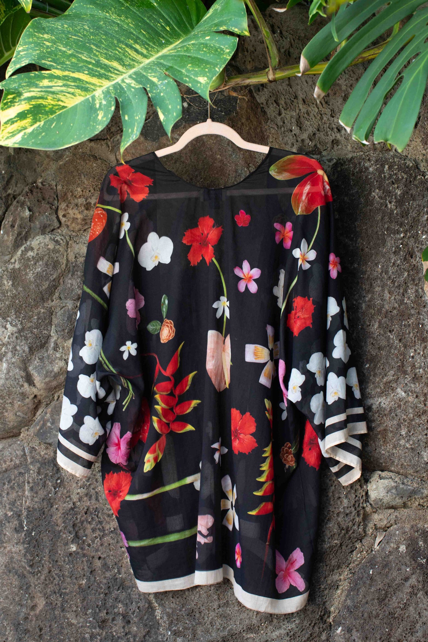 Elegant black cotton layering kimono with sophisticated Hawaiian floral motifs and flowing one-size silhouette by Lola Pilar.
