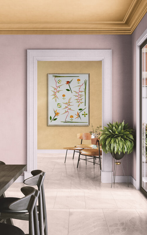 Lola Pilar flat lay composition of real Hawaiian botanicals with hanging heliconia, bird of paradise, kou blossoms, and naupaka leaves arranged on a white background.