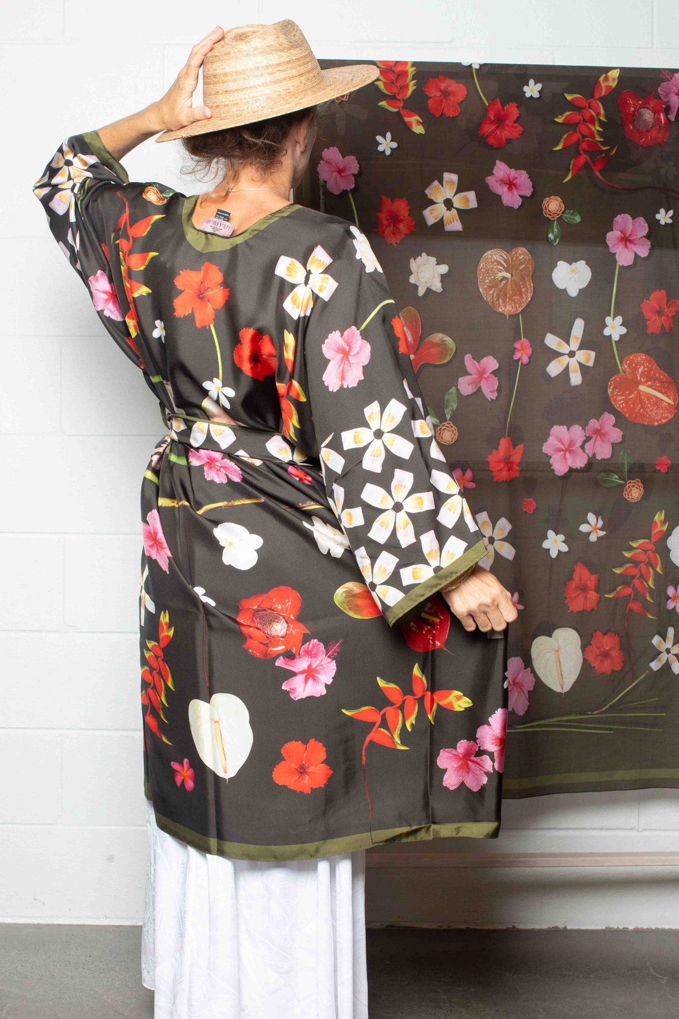Tropical moss green silk travel robe with elegant island botanical artwork in vivid pink, red, yellow, and white hues, made in Italy and designed in Hawaii.