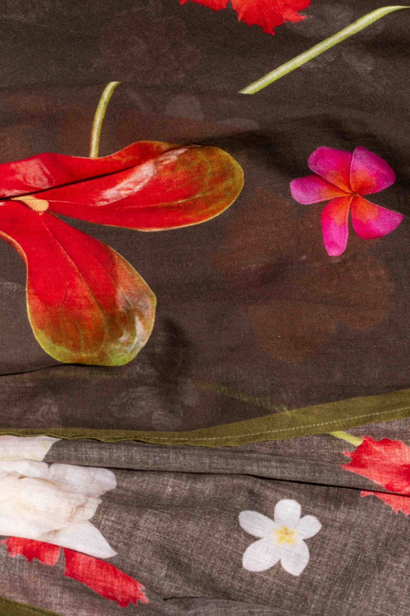 Lola Pilar luxury-inspired tropical cotton kimono top with colorful floral print on moss green fabric designed for stylish travel and island living.