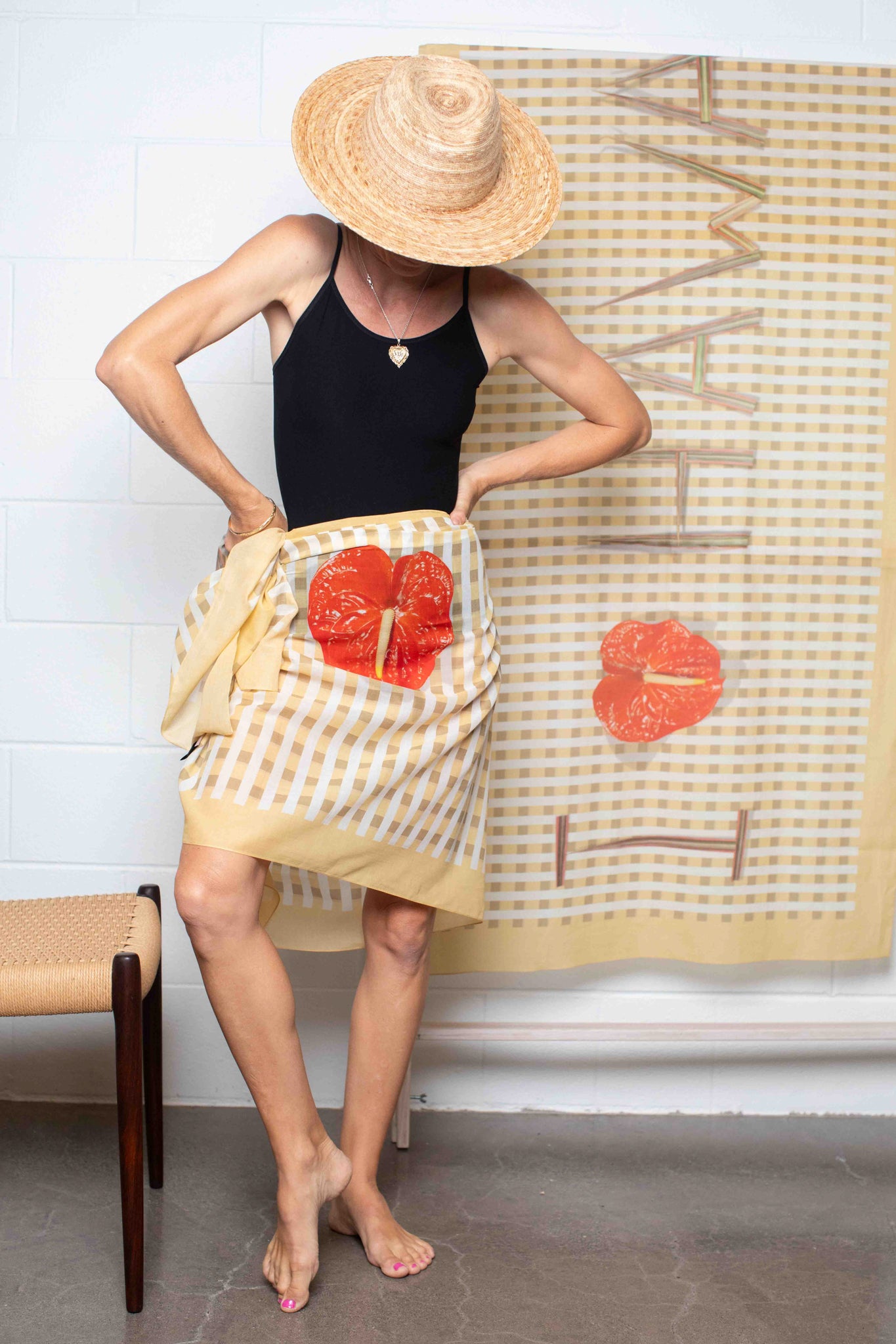 Yellow and white palaka pareo featuring “I Love Hawaii” text with a red anthurium flower, styled as a lightweight beach wrap and island cover-up. Lola Pilar 