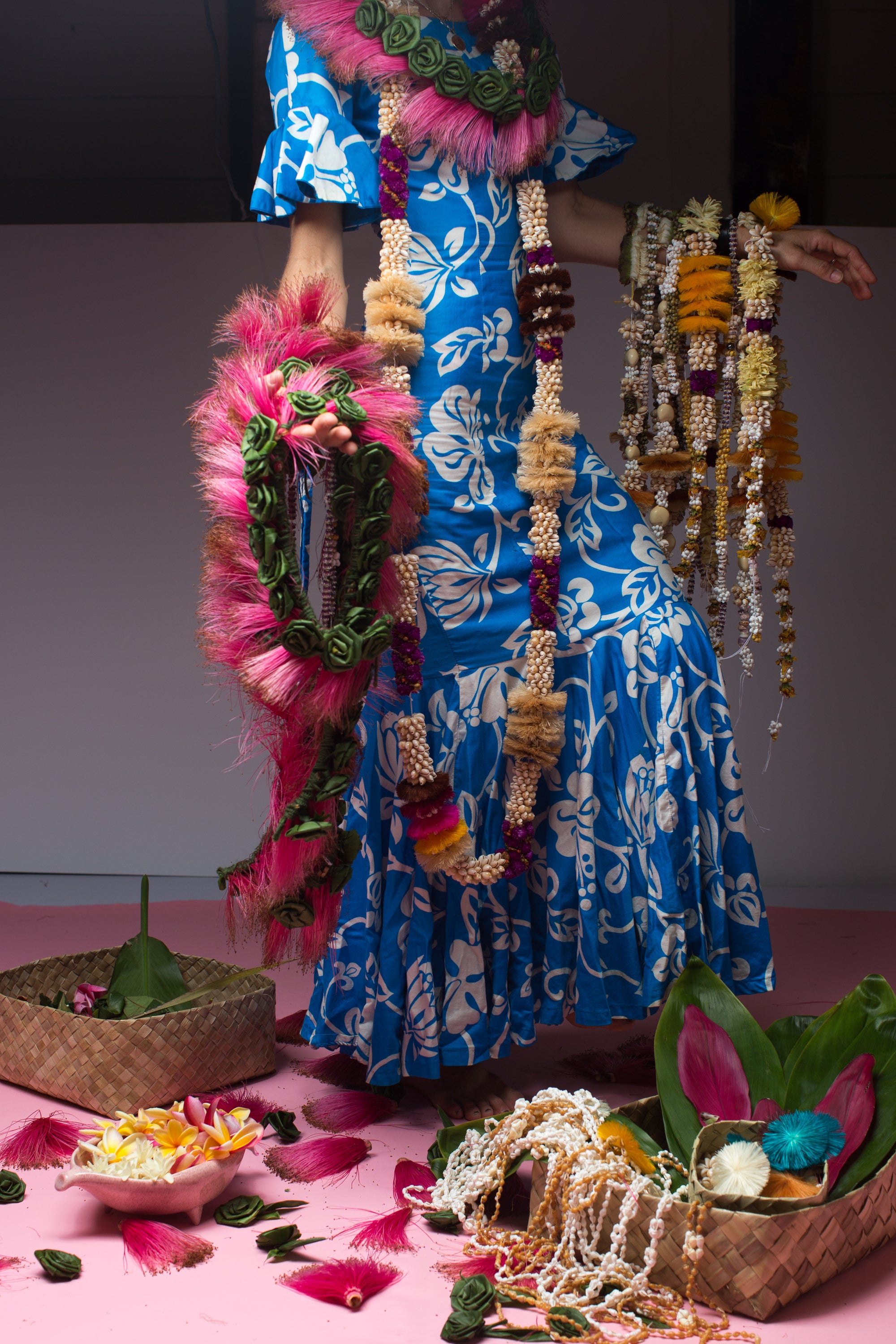 blue and white vintage mumu holding ocean dreamer leis and live a lei live leis for a collaboration