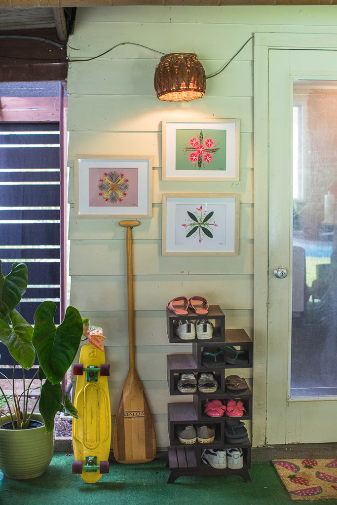 Grouping of three photographic plant images hanging on an outside lanai wall