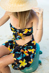 woman wearing a pareo / sarong on kailua beach featuring blue jade and yellow plumeria, designed in hawaii