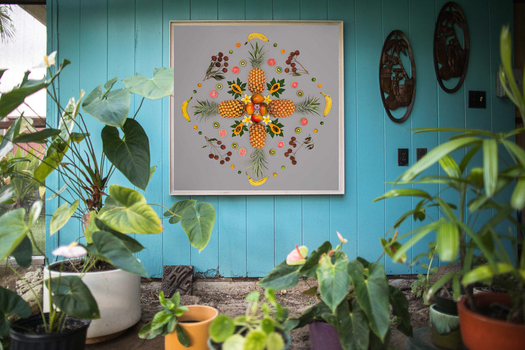 Chinatown Fruit Salad is placed on the wall among the tropical flowers near at a homes entryway.