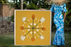 Woman in a hawaiian mumu holding a large 4ftx4ft photographic print with a handmade ash frame