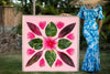 Woman in a Hawaiian mumu holding a large 4ftx4ft Mr. Bomaxstic photographic art inspired by the hawaiian quilt