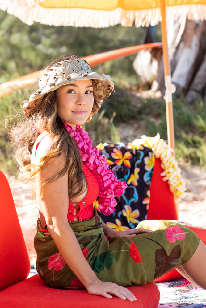 woman in the pualani pareo sarong on kailua beach. anthurium, Philodendron, hibiscus, and hibiscus leaves
