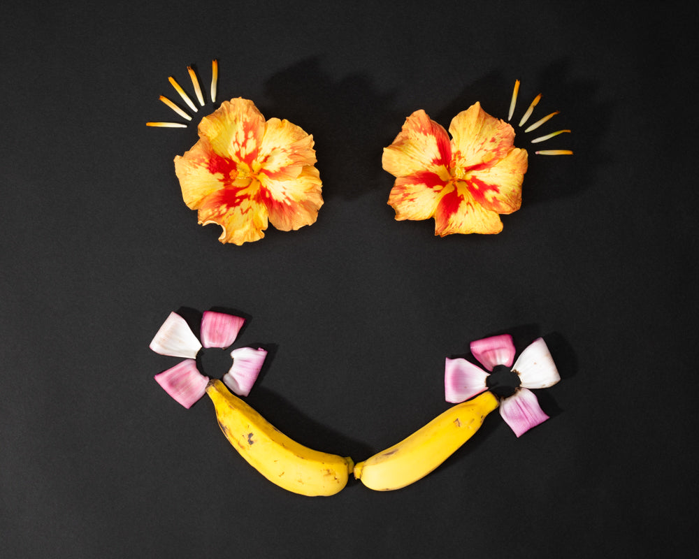 smile with a banana hibiscus eyes and musa ornata banana flowers and eyelashes